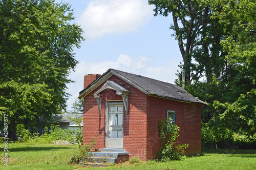 Photo of an old tiny brick house in the country