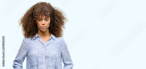 African american call center operator woman with a confident expression on smart face thinking serious photo