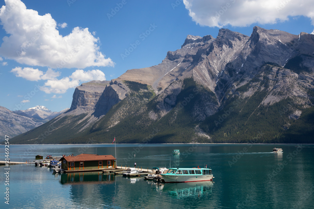 Banff, Alberta, Canada - June 20, 2018: Boats at the dock with a beautiful Canadian Mountain Landscape in the background.