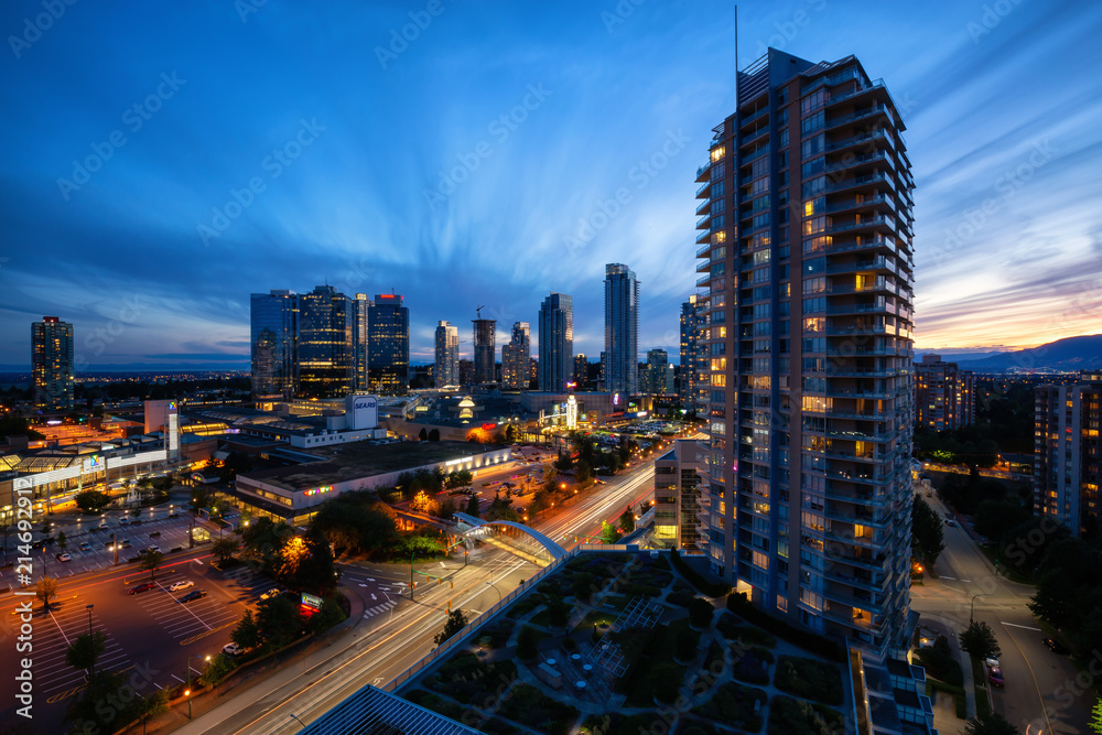 Fototapeta premium Burnaby, Vancouver, British Columbia, Canada - June 26, 2018: Aerial view of Metrotown Mall during a vibrant and colorful summer sunset.