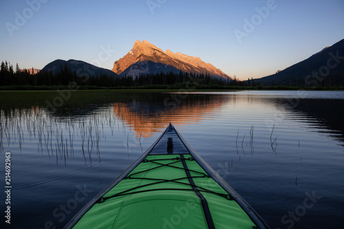 Kayaking in a beautiful lake surrounded by the Canadian Mountain Landscape. Taken in Vermilion Lakes, Banff, Alberta, Canada. © edb3_16