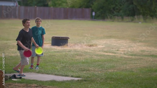 Two middle school brothers teeing off while playing frisbee golf.  Shot on a Blackmagic Ursa Mini Pro 4.6k with a Sigma 50-100mm f/1.8.