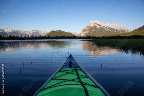 Kayaking in a beautiful lake surrounded by the Canadian Mountain Landscape. Taken in Vermilion Lakes, Banff, Alberta, Canada.