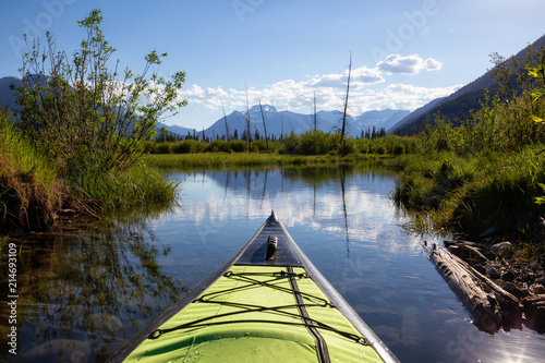 Kayaking in a beautiful lake surrounded by the Canadian Nature Landscape. Taken in Vermilion Lakes, Banff, Alberta, Canada.