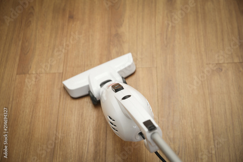 Cleaning hardwood floor with vacuum cleaner