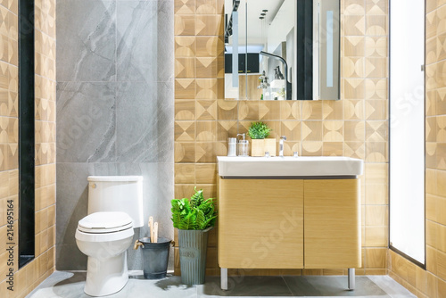 Modern spacious bathroom with bright tiles with toilet and sink.