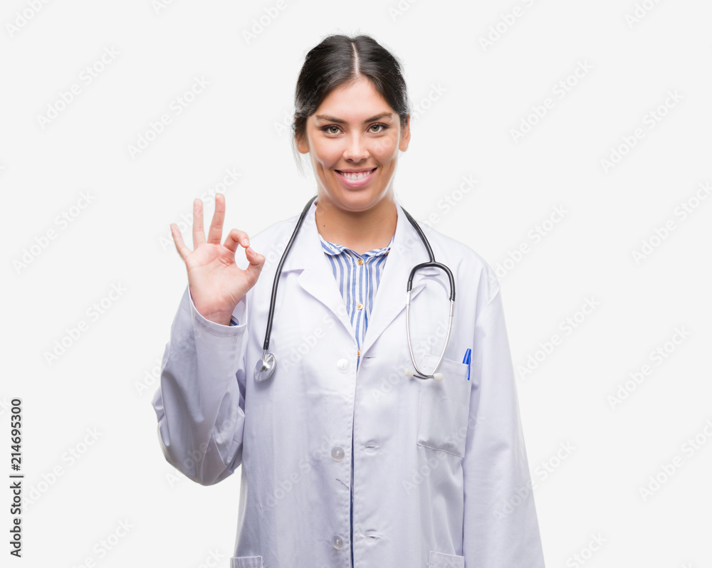 Young hispanic doctor woman doing ok sign with fingers, excellent symbol Young hispanic doctor woman doing ok sign with fingers, excellent symbol