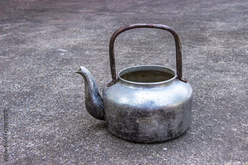 Classic old Kettle at put on concrete background.