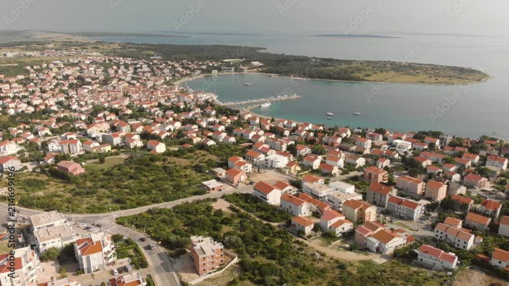 Town by the sea on a Mediterranean island on a sunny day, aerial, landscape, descending drone shot Town by the sea on a Mediterranean island on a sunny day, aerial, landscape, descending drone shot