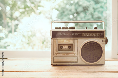 Photo of memorie and nostalgia. vintage radio or cassette reccorder in house. vintage color tone. photo