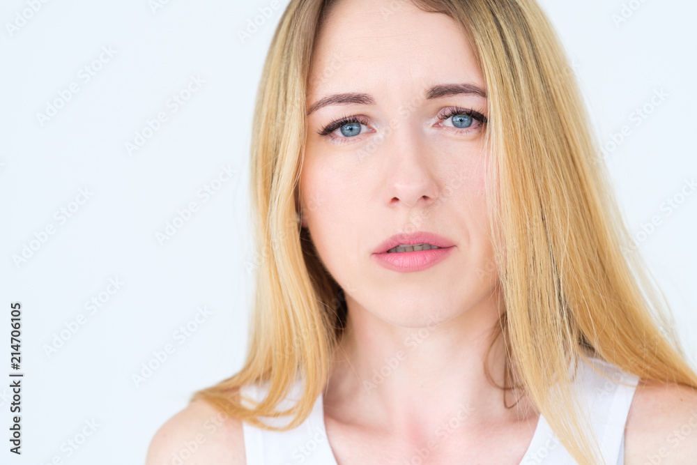 emotion face. moody grumpy sullen upset woman. young beautiful blond girl portrait on white background. emotion face. moody grumpy sullen upset woman. young beautiful blond girl portrait on white background.