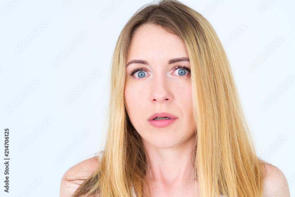 emotion face. overwhelmed perplexed shocked surprised astounded woman young beautiful blond girl portrait on white background.