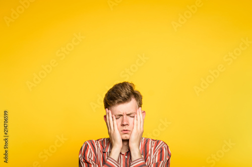 Photography sad rueful depressed cheerless man covering his face in hands