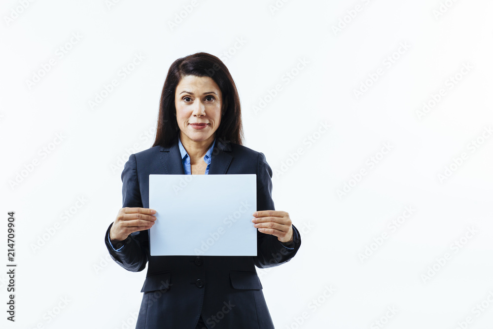 Portrait of a confident smiling woman in business suit holding blank sign Portrait of a confident smiling woman in business suit holding blank sign