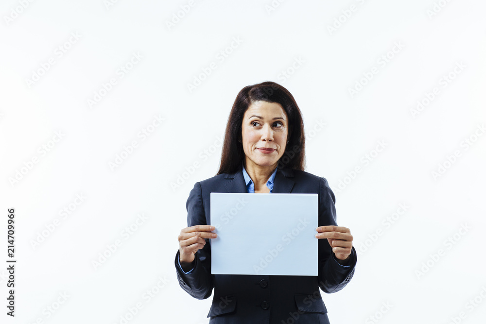 Portrait of a smiling woman holding blank sign and looking to side, isolated on white studio background Portrait of a smiling woman holding blank sign and looking to side, isolated on white studio background