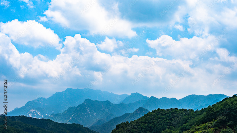 Far view of Mount Tai in summer time, with its peak was surrounded by cloud Far view of Mount Tai in summer time, with its peak was surrounded by cloud