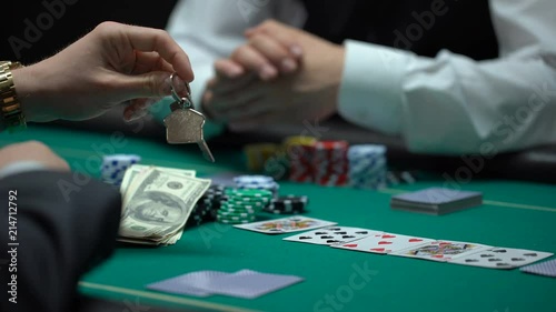 Confident businessman playing poker betting all property in risky game, gambling photo