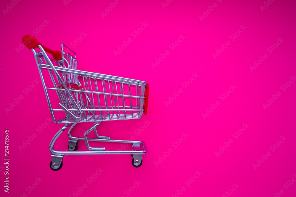empty shopping cart on magenta background empty shopping cart on magenta background