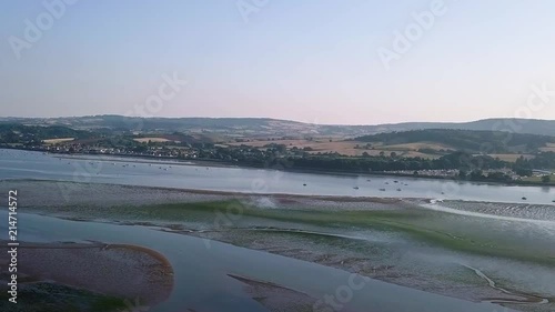 Landscape view of the beach town Lympstone England. The sky view shows the town, the beach, and the water formations off of the shore. photo