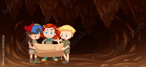 Children looking at map in cave