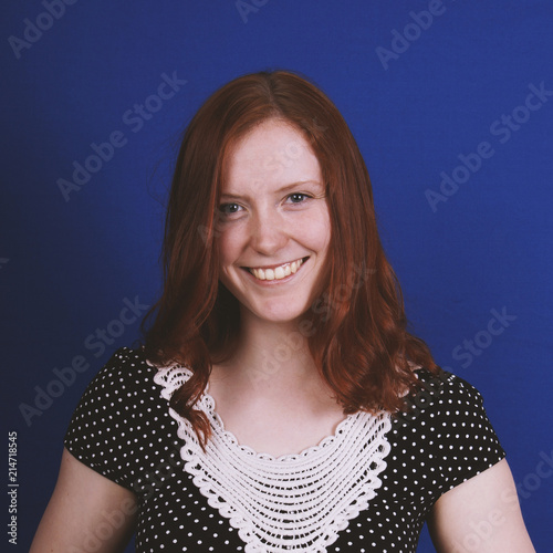 happy young woman with toothy smile and vintage dress photo