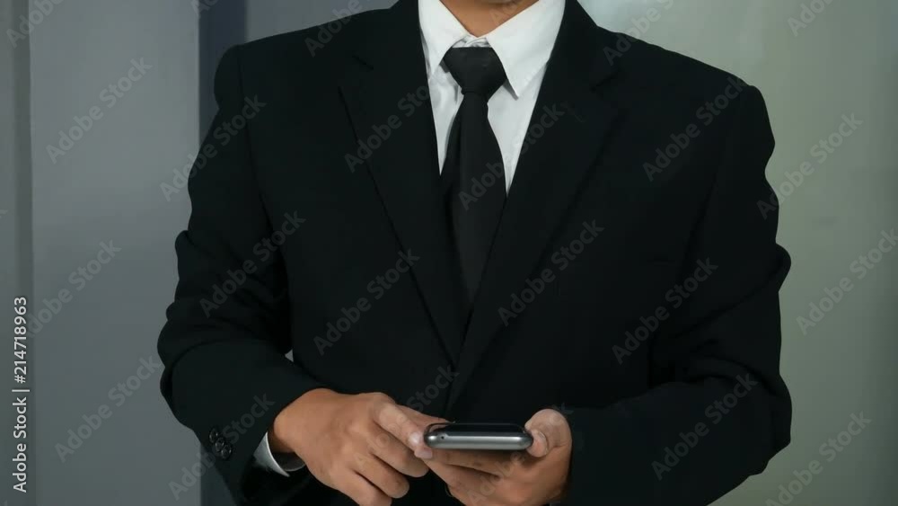 4k of business man holding smartphone and hand touching to virtual touch screen 4k of business man holding smartphone and hand touching to virtual touch screen