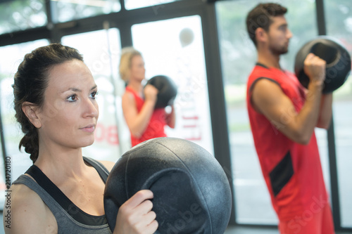 people working with kettle bell in a gym