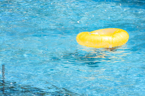 Summer vacation, flotation device and safety equipment for swimming concept with a lifesaver or life ring floating in a blue empty pool with copy space