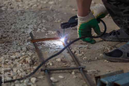 Worker welds metal at the construction site