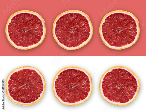 Grapefruit Slices On The Pink and White Background