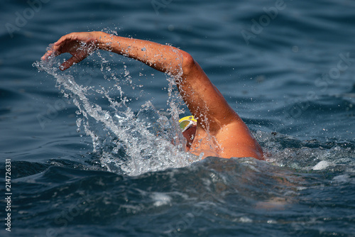 Man swimmer swimming crawl in blue sea,training for triathlon