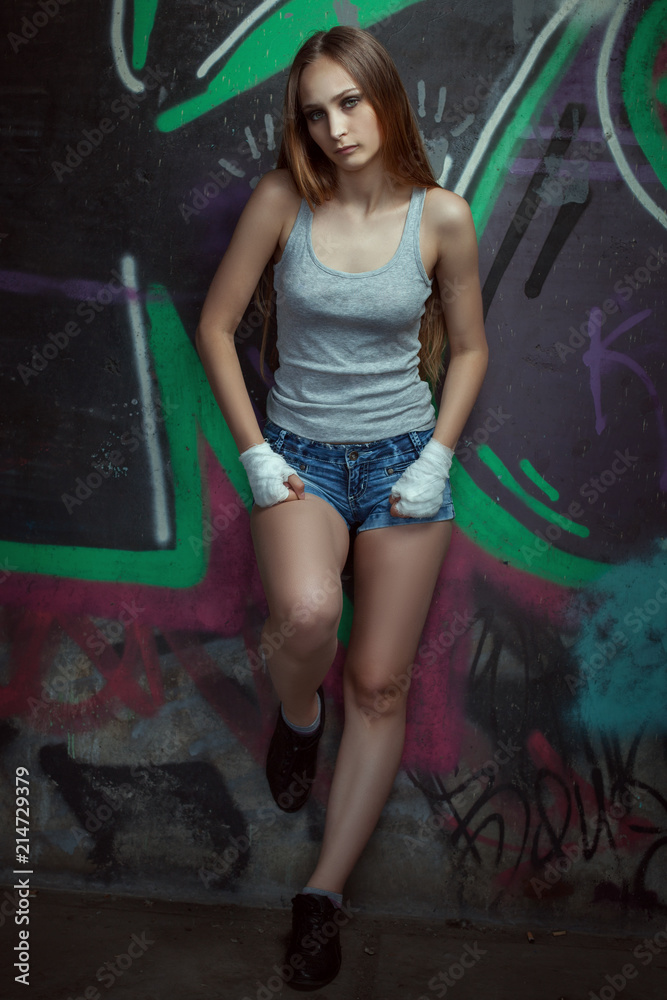 Fototapeta premium Portrait of a beautiful fighter girl under the bridge.