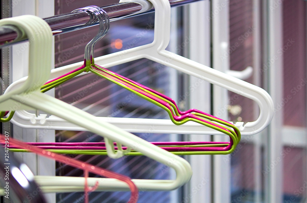 Empty hangers on the rack for clothes. Office space or school. Selective focus, side view, copy space. Empty hangers on the rack for clothes. Office space or school. Selective focus, side view, copy space.