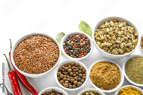 Bowls with various spices on white background