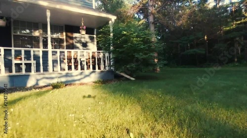 Drone footage along a house and through a yard. photo
