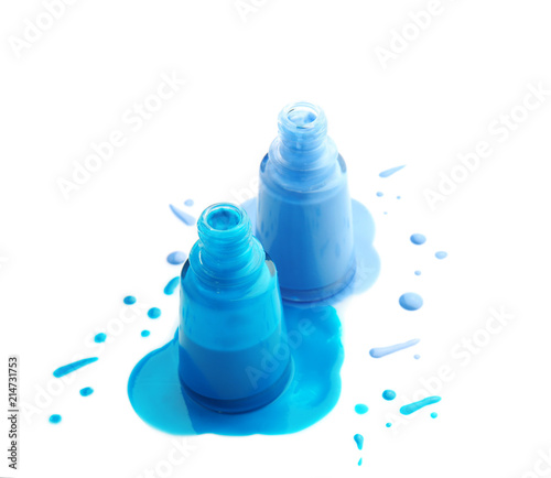 Open bottles of nail polishes on white background