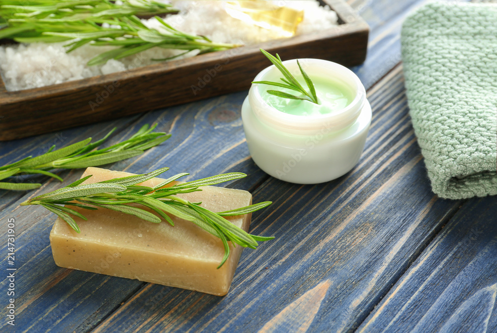 Handmade soap and cream with rosemary on wooden table Handmade soap and cream with rosemary on wooden table