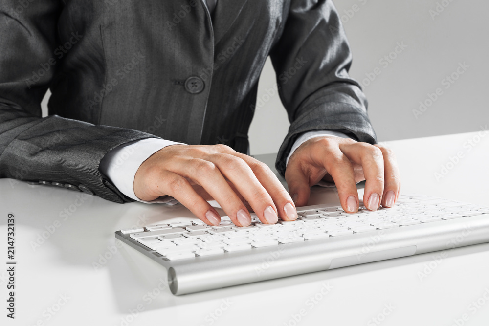 Closeup of businesswoman hand typing on keyboard with mouse on wood table Closeup of businesswoman hand typing on keyboard with mouse on wood table