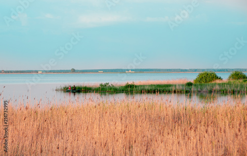 view of the lake and fishermen in a boat