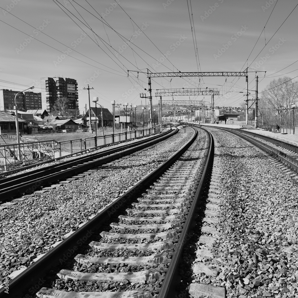 Railway tracks in front of the station, Prague. High contrast, black and white image. Electrical wires on supports Railway tracks in front of the station, Prague. High contrast, black and white image. Electrical wires on supports