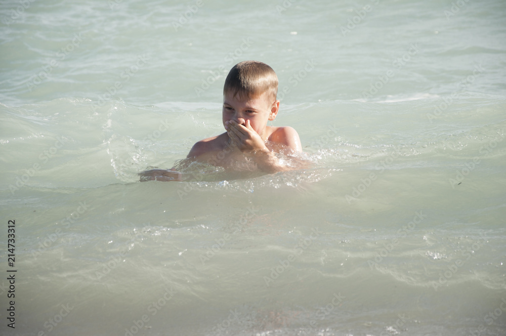 boy play with sea waves