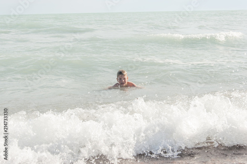 boy play with sea waves © vadim yerofeyev