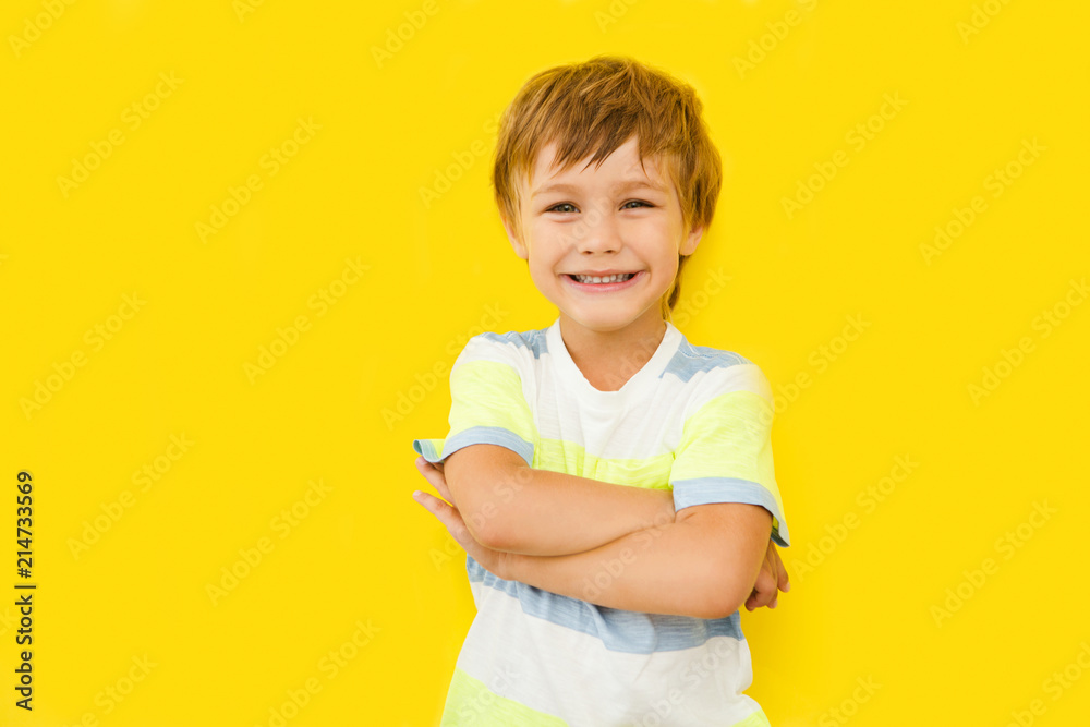 Portrait of a Cute smiling little boy on yellow background. Childhood concept. Portrait of a Cute smiling little boy on yellow background. Childhood concept.