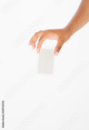 hand hold blank business card. female arm hold paper isolated on white background. copy space. mock up. photo