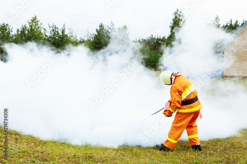 man extinguishes a fire with a fire extinguisher