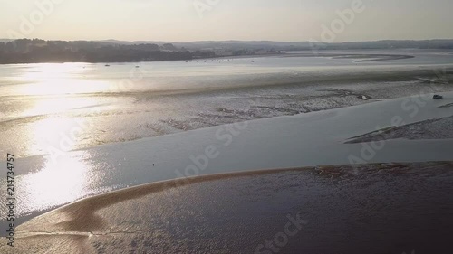 Side travelling aerial shot of a River, with beautiful Sunset sky reflection on the water. photo