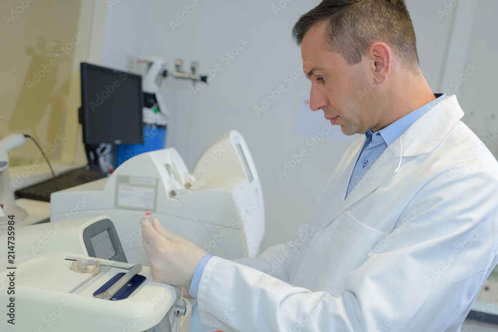 happy young male researcher working in his lab happy young male researcher working in his lab
