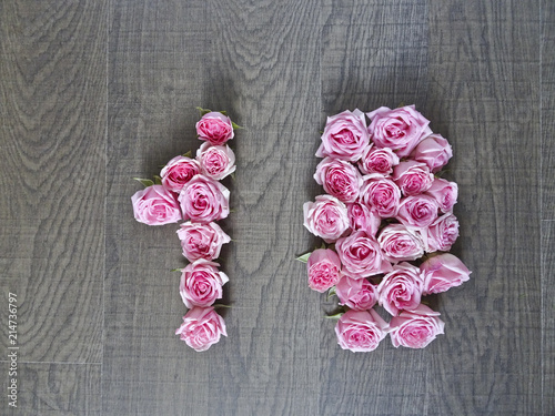 10, ten - vintage number of pink roses on the background of dark wood - for congratulations, postcards, websites, design, printing