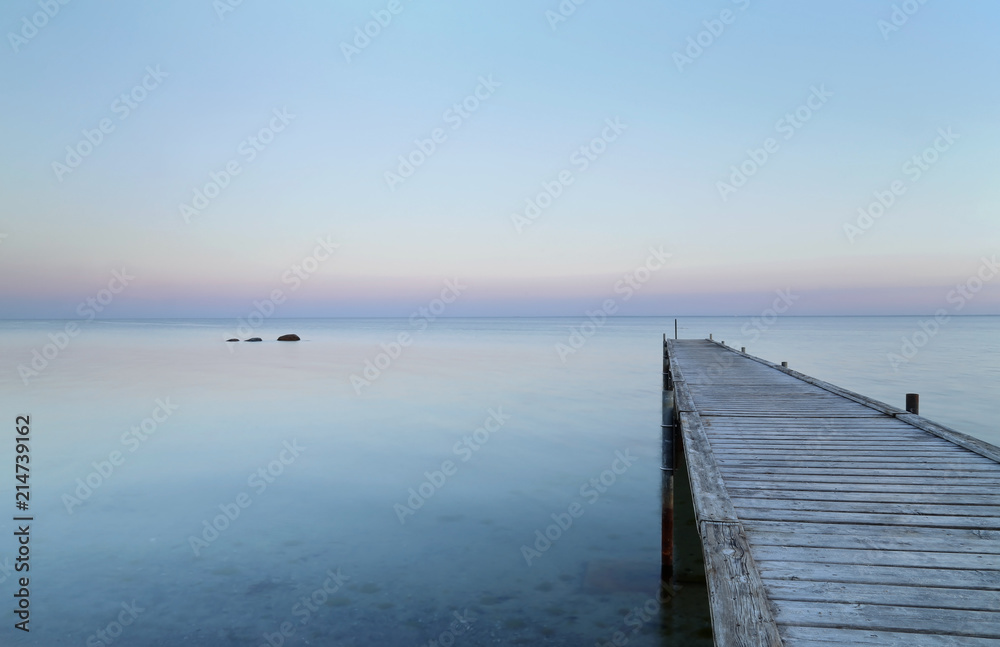 Obraz premium Wooden jetty in tranquil seashore at Brondbystrand, Denmark