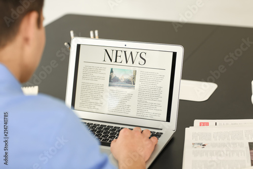Young businessman reading n...